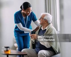 Hình ảnh về nurse assisting an elderly patient with a caring smile