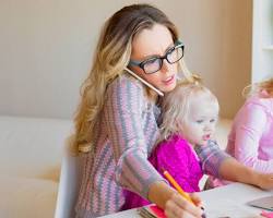 Hình ảnh về Working mom studying at home with her child nearby